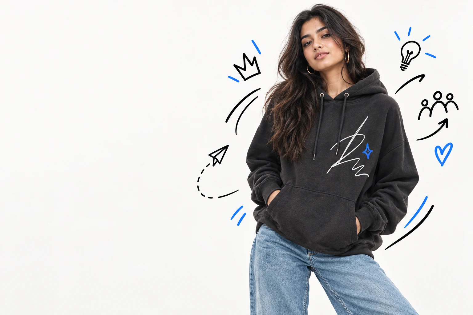 An Indian creator modelling a charcoal hoodie in an editorial studio campaign
